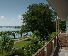 DAS HAUS AM SEE. Genießen Sie den direkten Seeblick von Ihrem privaten Balkon aus. Erleben Sie, wie das Haus mit dem See lebt und der stete Blick auf das Wasser den Rhythmus Ihres Aufenthalts bestimmt.