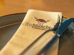 Serviette mit Logo und Schriftzug Das Blümchen Schwarzwald Tapas auf Teller – stilvolles Detail im Restaurant Das Blümchen Friedrichshafen.