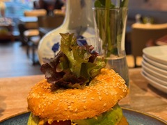 Die Feinschmecker Catering & Partyservice Hamburg - Vegetarisch belegter Sesam-Bagel mit Avocado, Tomate, würzigem Aufstrich und frischem Blattsalat. Herzhaftes Gericht für Frühstück, Mittagessen oder Cafébesuch.