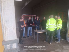 Curry-Flitzer e. K. - Mobiles Currywurst-Catering bei einer Bauleiterbesprechung am Mercedes-Benz Werk in Düsseldorf am 8. Oktober 2026. Zu sehen sind Teilnehmer einer Baustellenbesprechung mit Cateringwagen im Hintergrund.